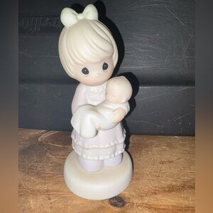 Precious Moments Figurine- “special delivery”.- holding  a baby.